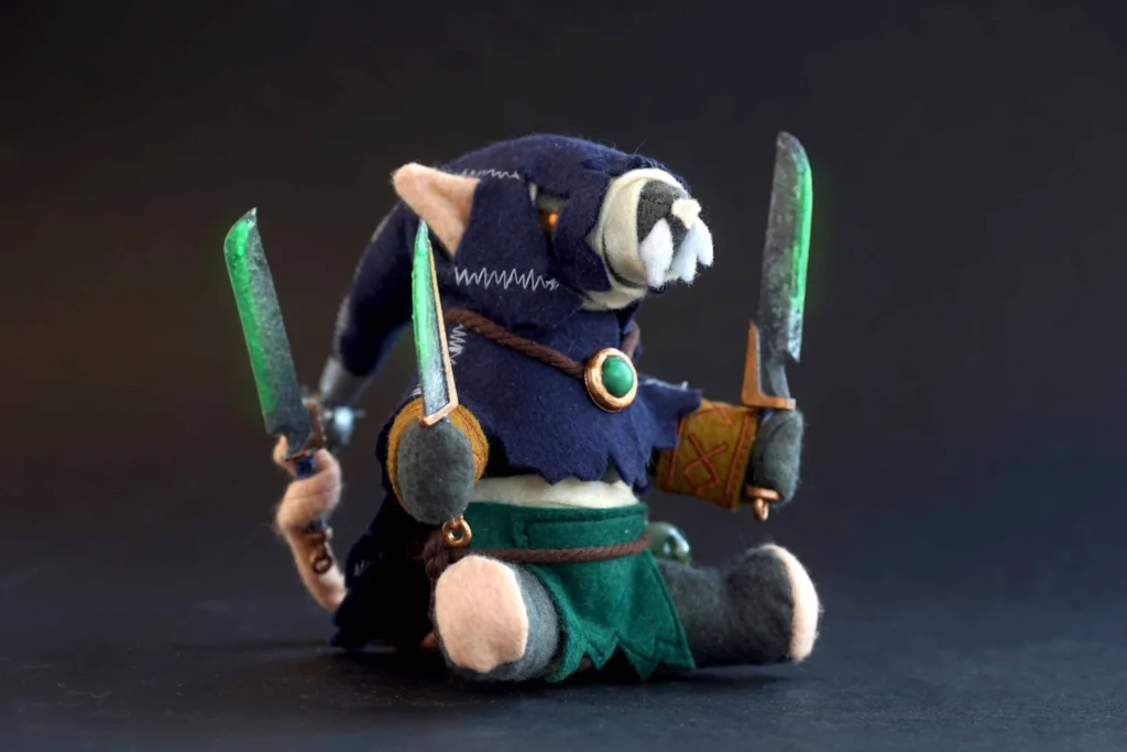 The Jongleurs Dream presents a Deathmaster Snikch plush collectible - A cuddly version of the legendary Skaven assassin, featuring his iconic hooded appearance and twin weeping blades. This grimdark décor plushie is perfect for fantasy wargame enthusiasts and collectors of the miniature tabletop game