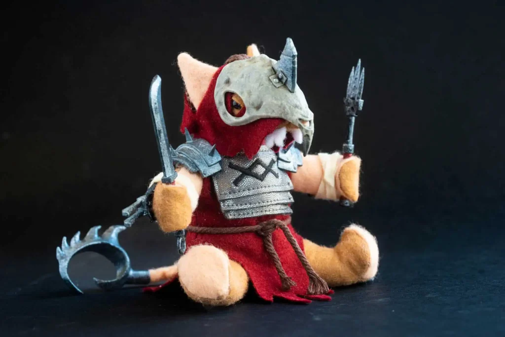 The Jongleurs Dream presents Tretch Craventail, the treacherous and cunning warlord of the grimdark fantasy world, now reimagined as a premium plushie collectible. This detailed desk display piece captures his iconic sneaky demeanor and tattered armor in soft fabric form.