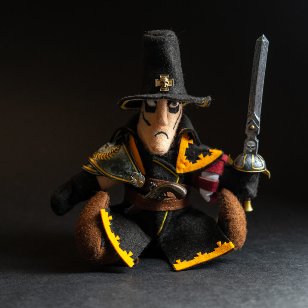 Handmade felt witch hunter plush inspired by Saltzpyre from Vermintide, wearing a wide-brimmed hat and long coat, made by The Jongleur's Dream